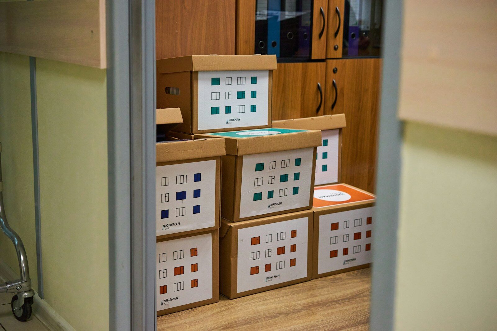 brown cardboard boxes on brown wooden shelf